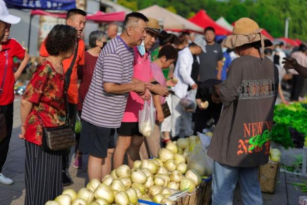 Shoppers at an open-air market in Shenyang, China's northeast Liaoning Province, on July 10, 2023. (STR/AFP via Getty Images)
