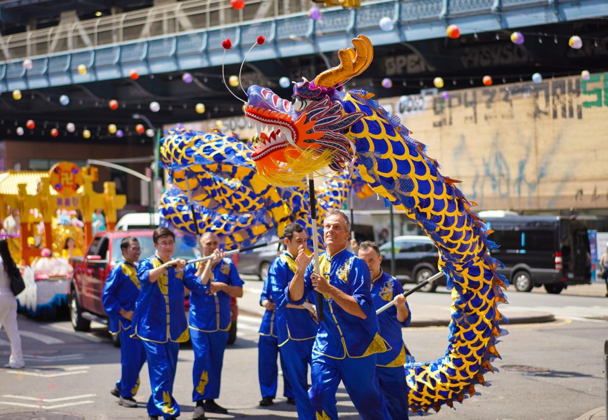 Falun Gong practitioners take part in a parade to commemorate the 24th anniversary of the persecution of the spiritual discipline in China, in New York's Chinatown on July 15, 2023. (Samira Bouaou/The Epoch Times)