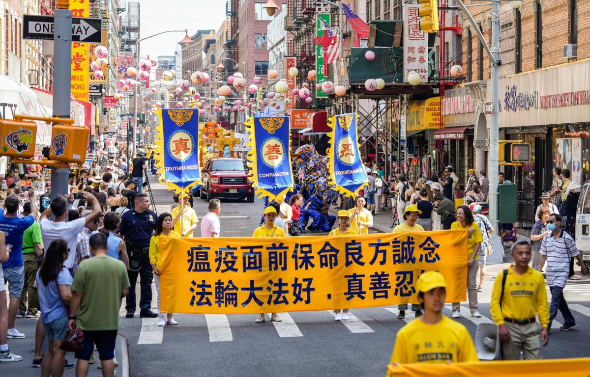 Falun Gong practitioners take part in a parade to commemorate the 24th anniversary of the persecution of the spiritual discipline in China, in New York's Chinatown on July 15, 2023. (Samira Bouaou/The Epoch Times)