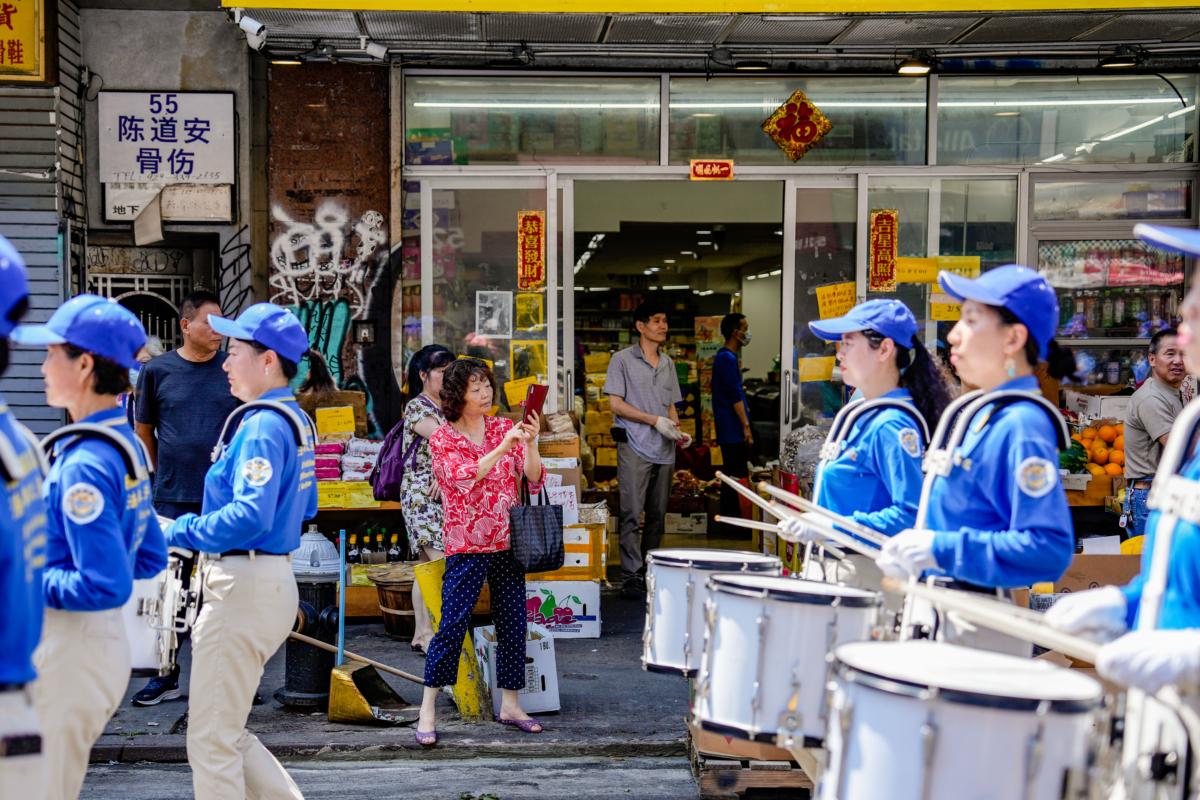 Falun Gong practitioners take part in a parade to commemorate the 24th anniversary of the persecution of the spiritual discipline in China, in New York's Chinatown on July 15, 2023. (Samira Bouaou/The Epoch Times)