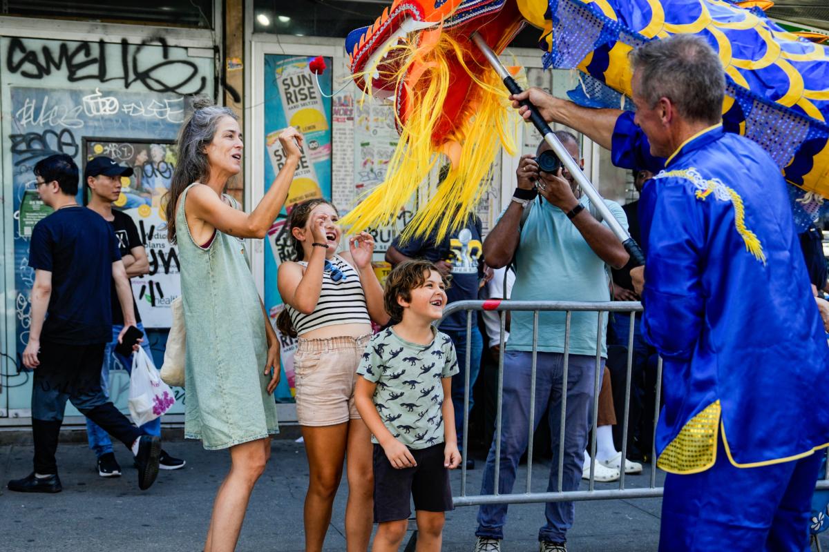 Falun Gong practitioners take part in a parade to commemorate the 24th anniversary of the persecution of the spiritual discipline in China, in New York's Chinatown on July 15, 2023. (Samira Bouaou/The Epoch Times)