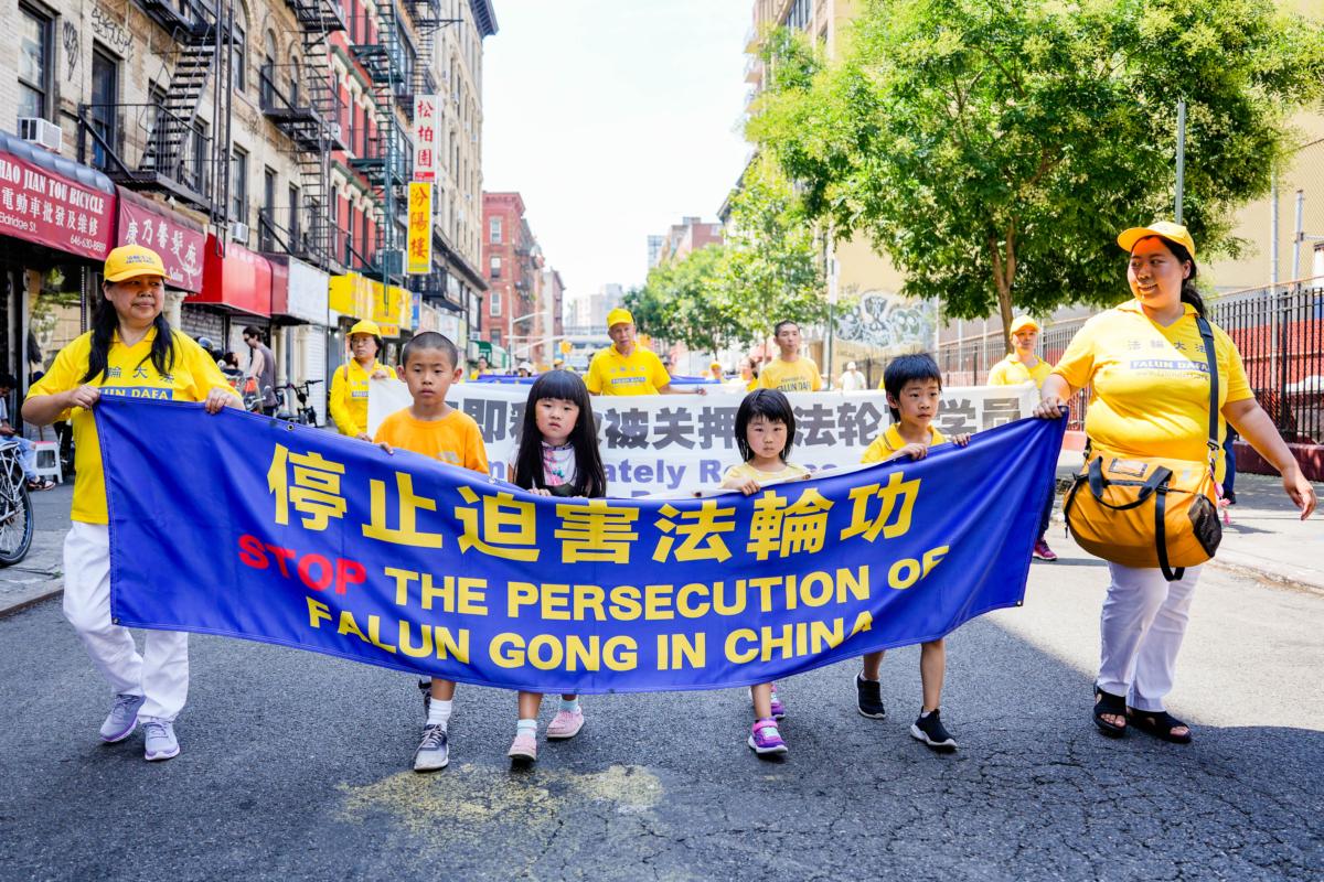 Falun Gong practitioners take part in a parade to commemorate the 24th anniversary of the persecution of the spiritual discipline in China, in New York's Chinatown on July 15, 2023. (Samira Bouaou/The Epoch Times)