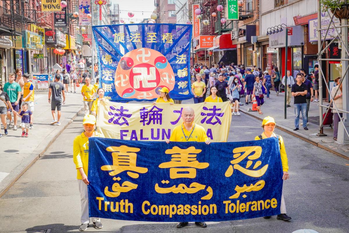Falun Gong practitioners take part in a parade to commemorate the 24th anniversary of the persecution of the spiritual discipline in China, in New York's Chinatown on July 15, 2023. (Jingyi Zhang/The Epoch Times)
