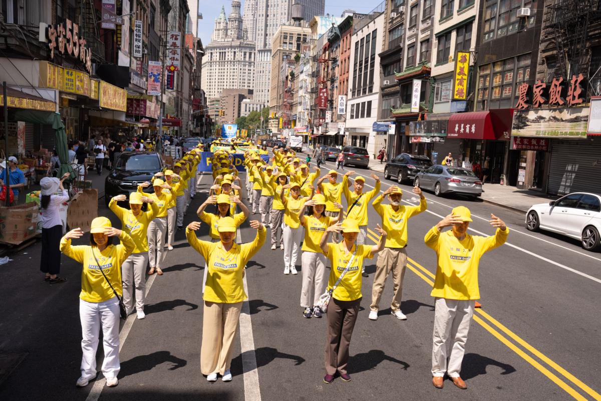 Falun Gong practitioners take part in a parade to commemorate the 24th anniversary of the persecution of the spiritual discipline in China, in New York's Chinatown on July 15, 2023. (Larry Dye/The Epoch Times)