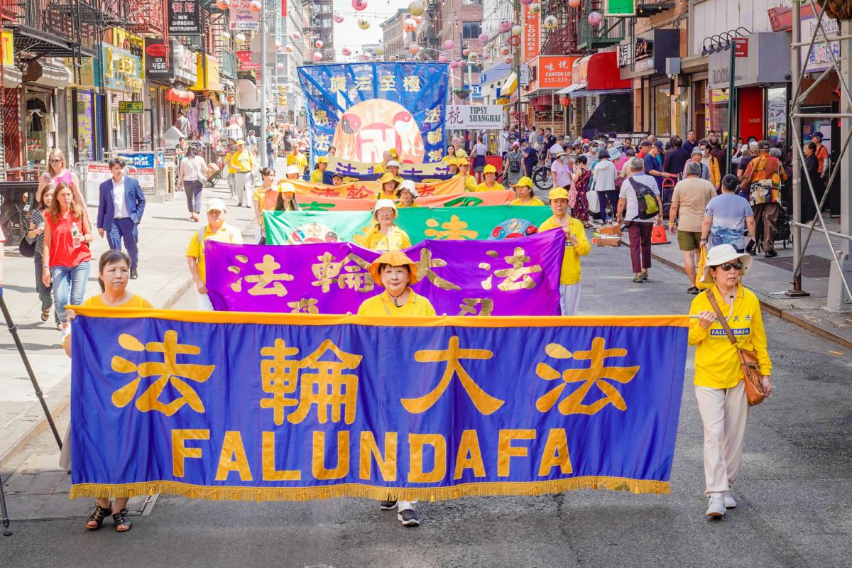 Falun Gong practitioners take part in a parade to commemorate the 24th anniversary of the persecution of the spiritual discipline in China, in New York's Chinatown on July 15, 2023. (Jingyi Zhang/The Epoch Times)