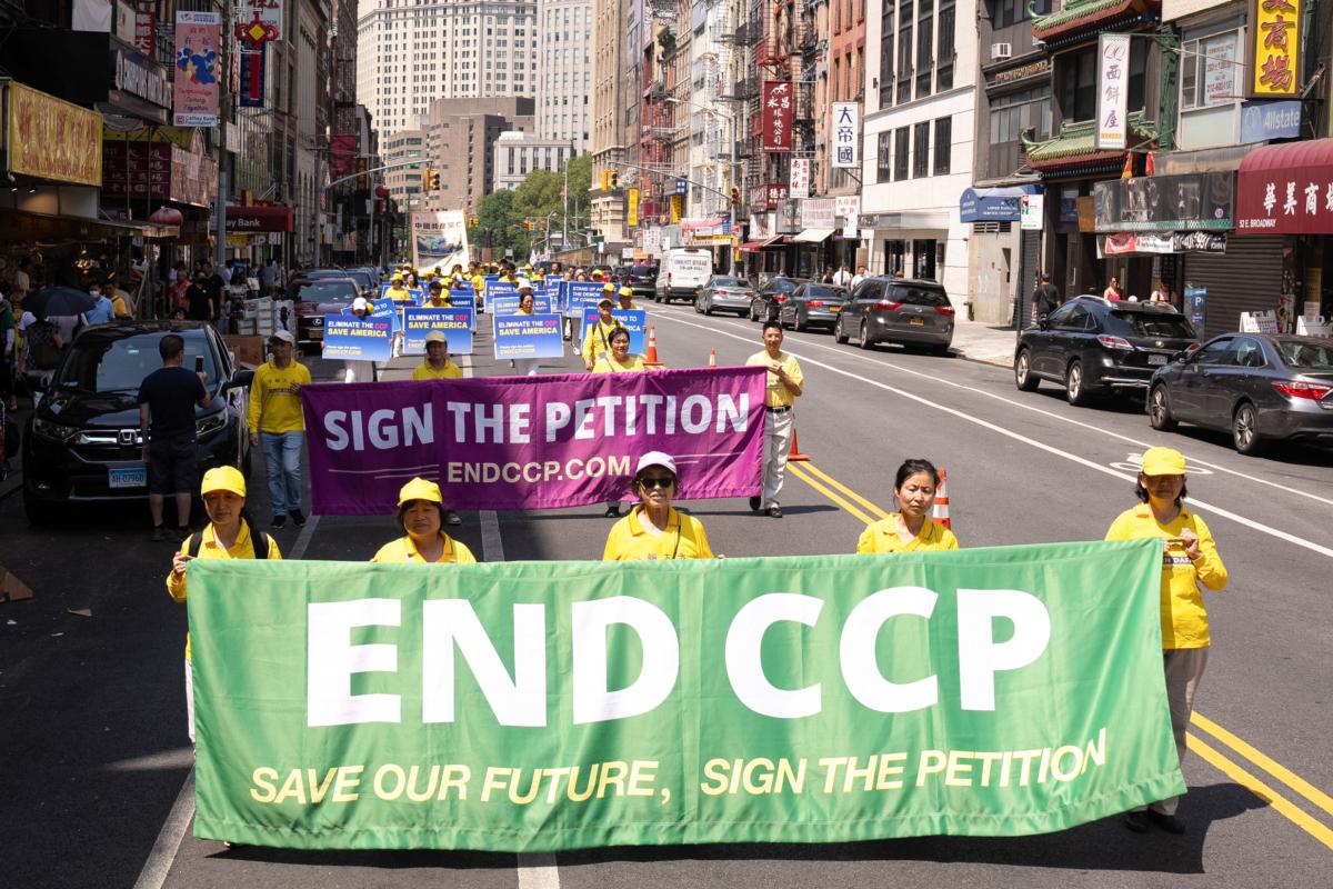 Falun Gong practitioners take part in a parade to commemorate the 24th anniversary of the persecution of the spiritual discipline in China, in New York's Chinatown on July 15, 2023. (Larry Dye/The Epoch Times)