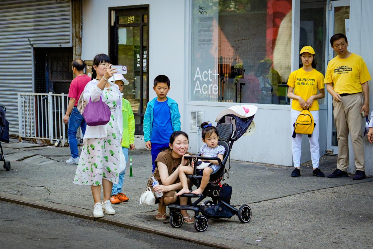 Falun Gong practitioners take part in a parade to commemorate the 24th anniversary of the persecution of the spiritual discipline in China, in New York's Chinatown on July 15, 2023. (Samira Bouaou/The Epoch Times)