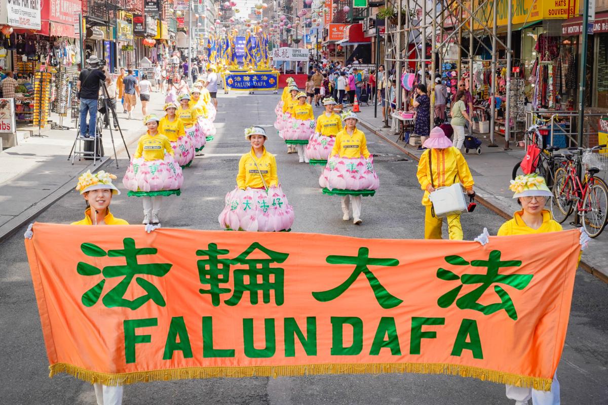 Falun Gong practitioners take part in a parade to commemorate the 24th anniversary of the persecution of the spiritual discipline in China, in New York's Chinatown on July 15, 2023. (Jingyi Zhang/The Epoch Times)