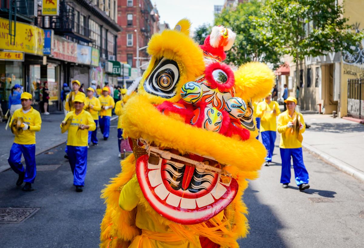 Falun Gong practitioners take part in a parade to commemorate the 24th anniversary of the persecution of the spiritual discipline in China, in New York's Chinatown on July 15, 2023. (Samira Bouaou/The Epoch Times)
