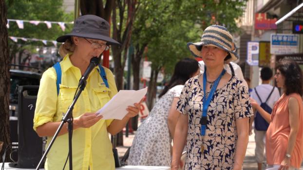 Lichun Shen (right) shared her personal story at the Philadelphia Chinatown rally on July 15, 2023. She had been illegally imprisoned for a total of nearly 11 years in China because of practicing Falun Gong. (William Huang/The Epoch Times)