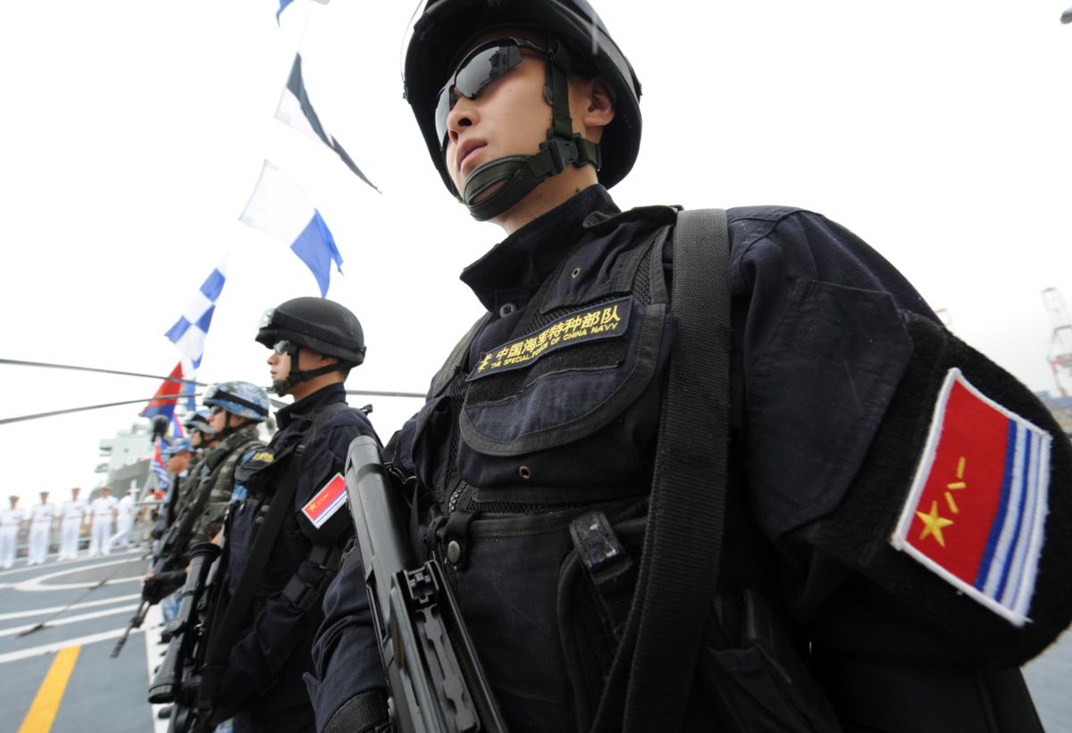People's Liberation Army (PLA) Navy special force members stand on the deck of China's Task Force 525 flagship missile frigate Ma'Anshan which saw action in Somalia against pirates as the ship anchors at the international port in Manila on April 13, 2010. (Ted Aljibe /AFP via Getty Images)