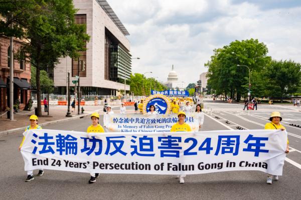 Falun Gong adherents march to mark the 24th anniversary of the Chinese regime’s persecution of the spiritual discipline in Washington on July 20, 2023. (Samira Bouaou/The Epoch Times)