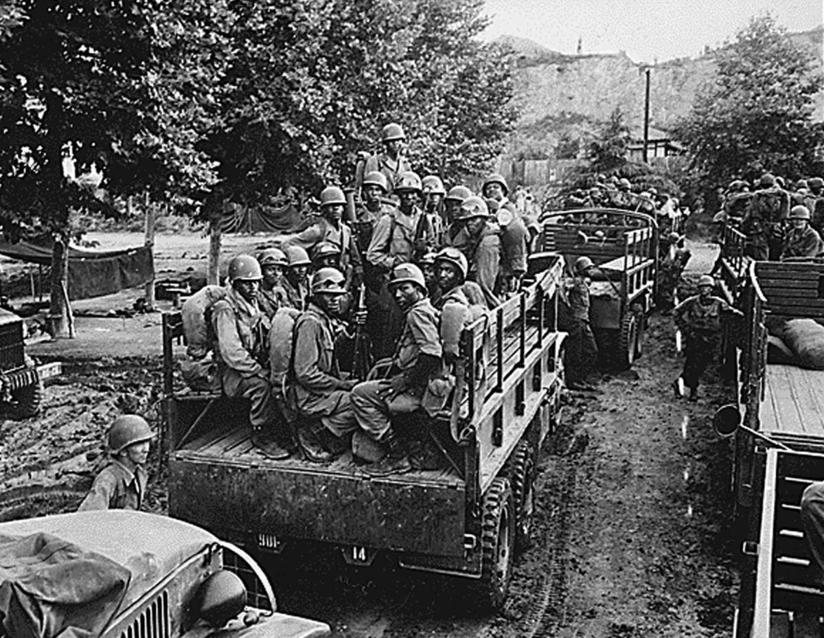 Men of the U.S. Army 24th Infantry Regiment loaded on trucks for transport to the front line during the Korean War on July 18, 1950. (National Archives/AFP via Getty Images)