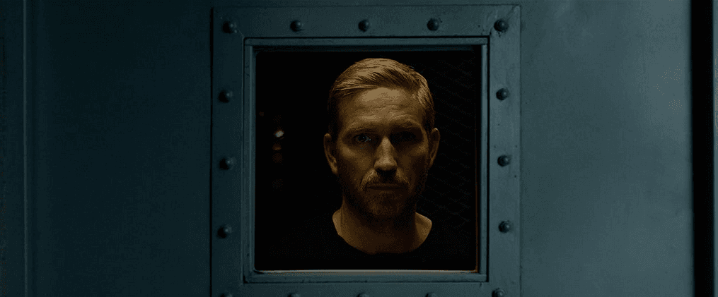 Agent Tim Ballard (Jim Cavieziel) looks in on a captive pedophile in "Sound of Freedom." (Angel Studios)