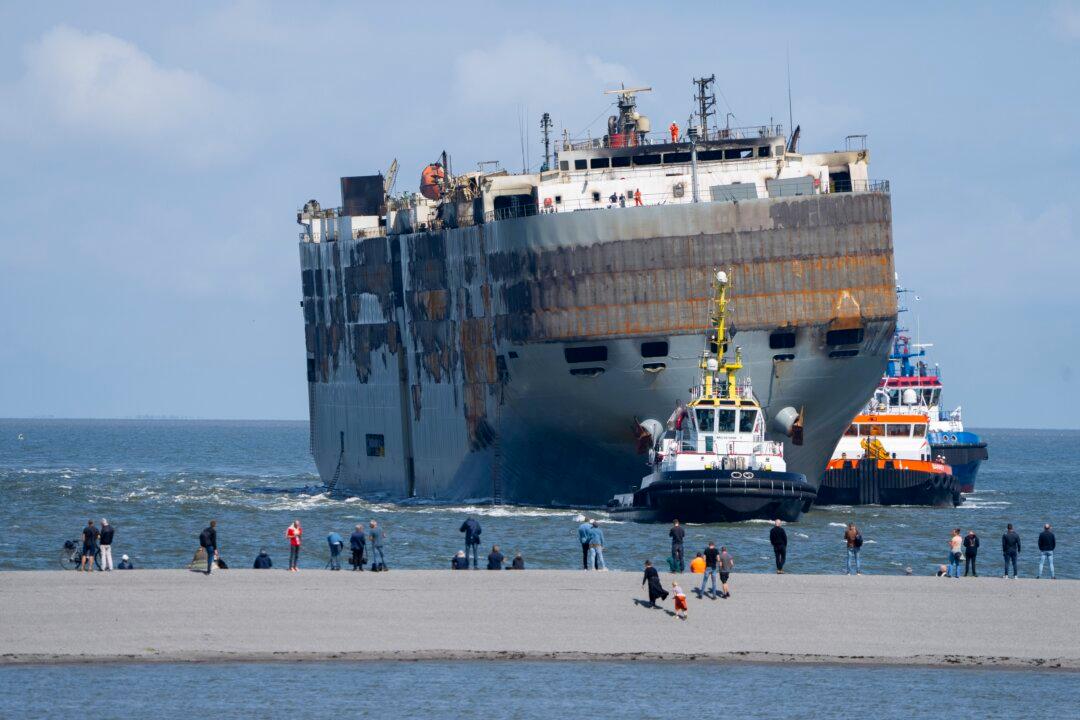 A Car-Carrying Ship That Burned for a Week on the North Sea Is Towed to a Dutch Port for Salvaging