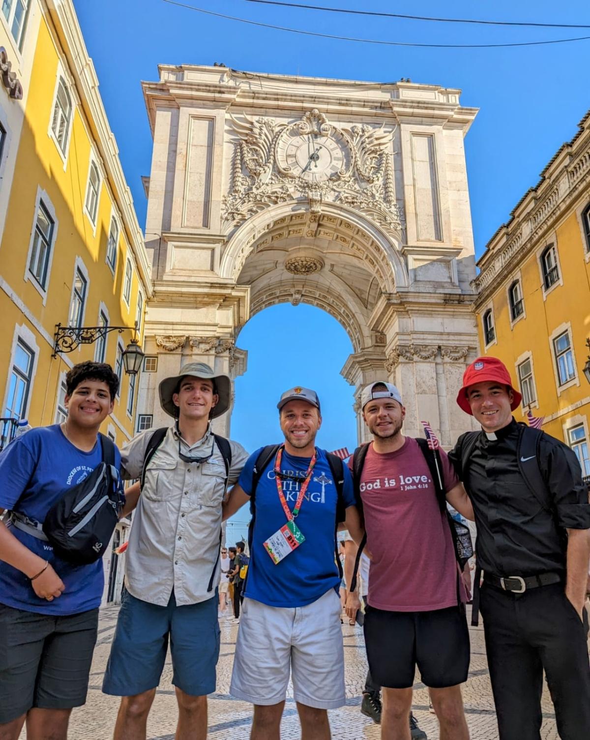 Florida Catholic seminary students Ricardo David Velasco (L), Caleb Malec (2nd L), and Tyler Gates (C) pose with fellow World Youth Day pilgrims in Lisbon, Portugal, on Aug. 4, 2023. (Courtesy of Tyler Gates)