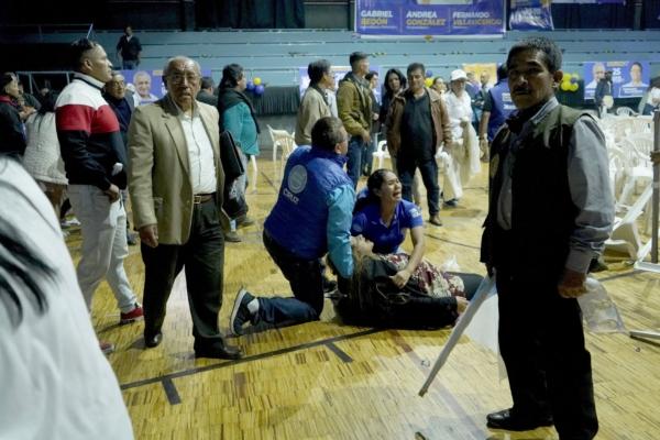 A woman is assisted after a mass shooting at the end of the campaign rally of Ecuadorian presidential candidate Fernando Villavicencio, who was assassinated in the attack in Quito, Ecuador, on Aug. 9, 2023. (AFP via Getty Images)