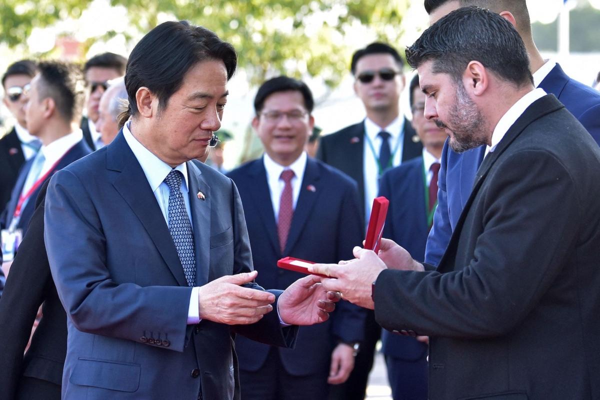 Taiwan's Vice President William Lai Ching-te (L) receives the Key to the City from Asuncion's Mayor Oscar Rodriguez upon landing at Silvio Pettirossi International Airport in Luque, Paraguay, on Aug.14, 2023, where he arrived to attend the inauguration of President-elect Santiago Pena. (Norberto Duarte/AFP via Getty Images)