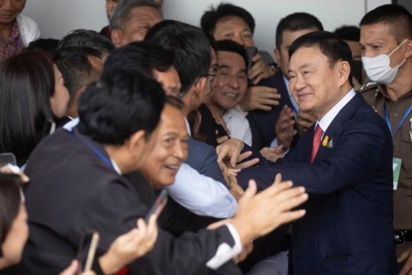 Thailand's former Prime Minister Thaksin Shinawatra (2nd R) is greeted by supporters on his arrival at Don Muang airport in Bangkok on Aug. 22, 2023. (Wason Wanichakorn/AP Photo)