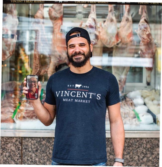 Peter DeLuca Jr., with his father, Peter Sr., on the phone screen. They continue the legacy of Peter Sr.’s father, Vincent, who opened Vincent’s Meat Market in 1954. ((Andrea Behrends))