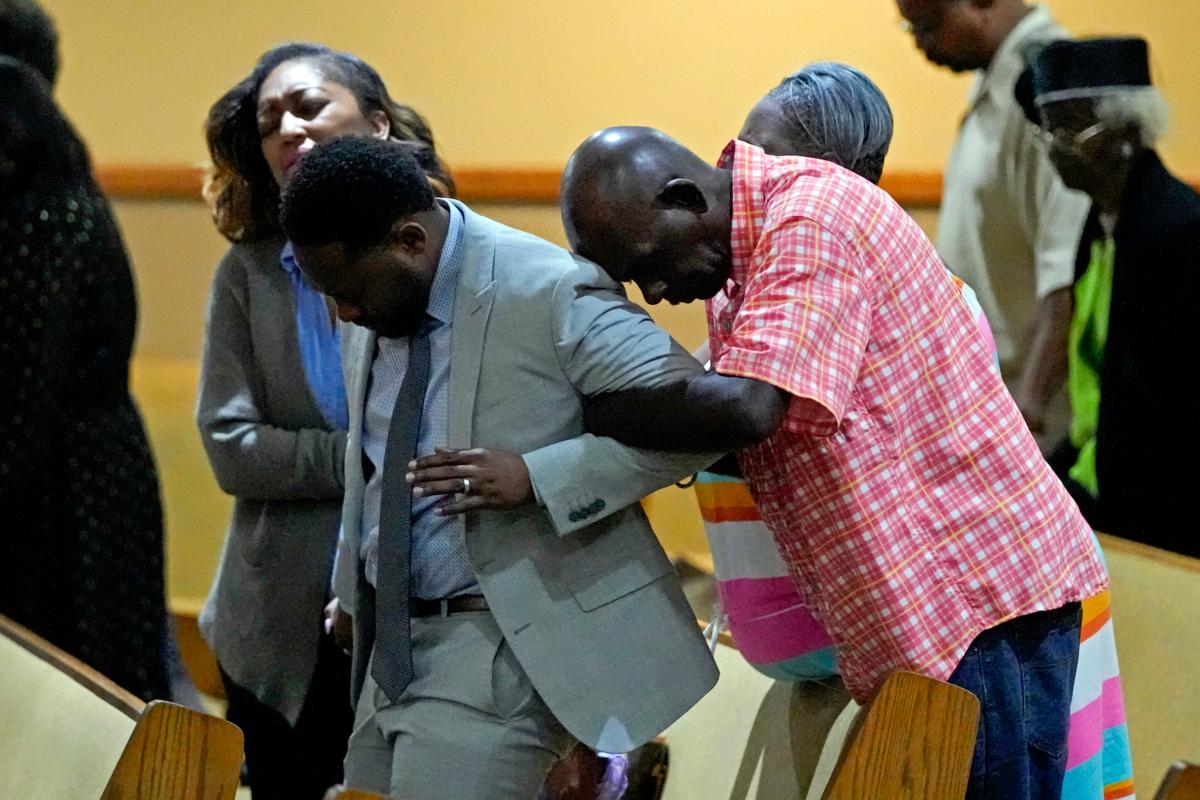 Parishioners pray at St. Paul A.M.E. Church in Jacksonville, Fla., on Aug. 27, 2023, the day after three people were killed in a racially motivated shooting at a nearby Dollar General store. (John Raoux/AP Photo)