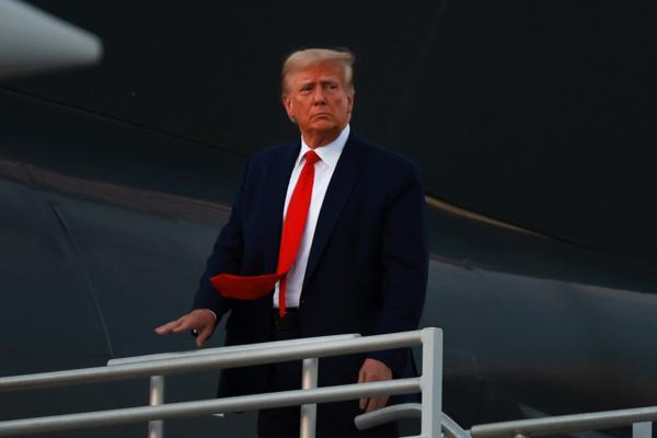 Former President Donald Trump boards his private airplane, also known as Trump Force One, as he departs Atlanta Hartsfield-Jackson International Airport after being booked at the Fulton County jail in Atlanta, Ga., on Aug. 24, 2023. (Joe Raedle/Getty Images)