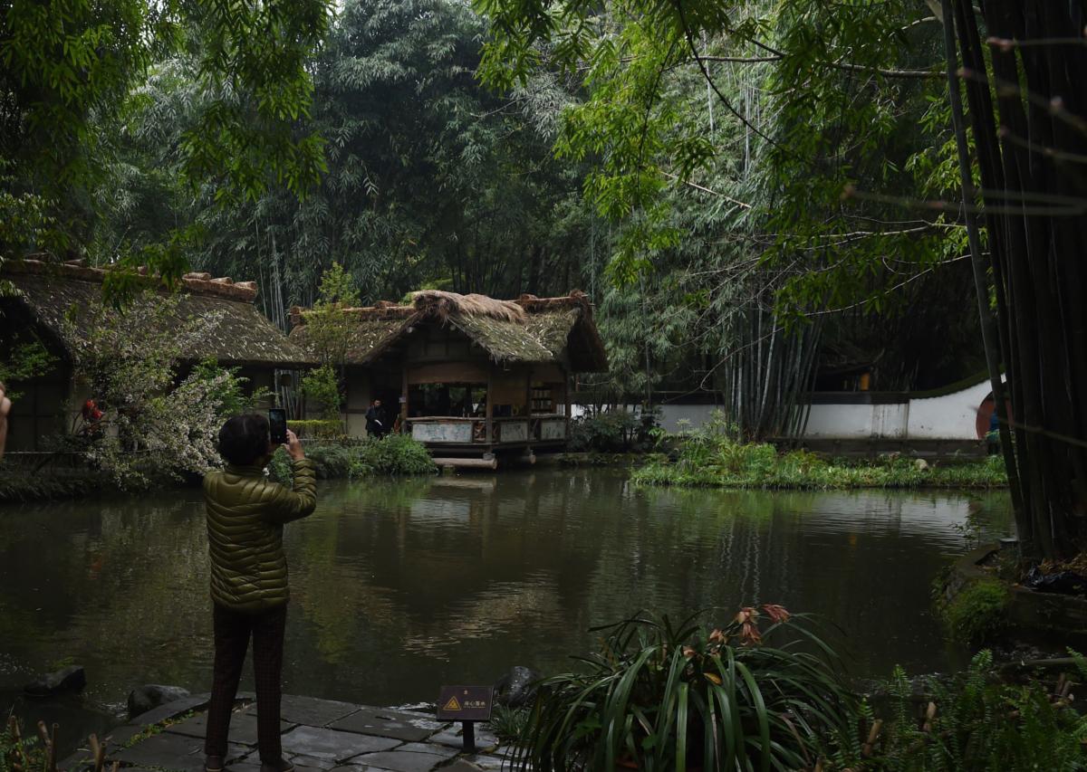 Visitors are taking photos in a park dedicated to Tang Dynasty poet Du Fu, in Chengdu, in southwest China's Sichuan Province on March 24, 2016. The park is built around the site of a former home of Du Fu, who stayed there for four years from A.D. 759. (Greg Baker/AFP via Getty Images)