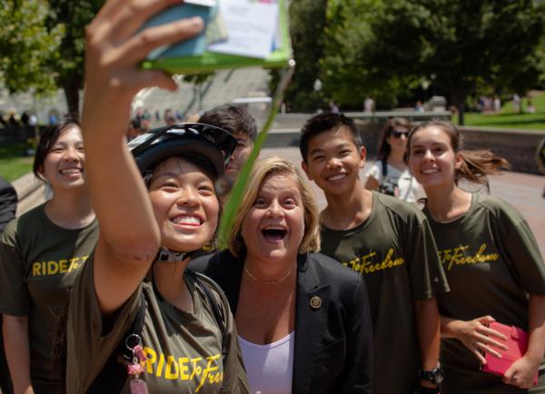 Ride to Freedom bikers Annie Chen (L) and her group take a selfie with Rep. Ileana Ros-Lehtinen (R-Fla.) on the West Lawn of the U.S. Capitol Building upon their arrival in Washington on July 16, 2015, during activities to commemorate the 16 years of persecution of Falun Gong in China. (Petr Svab/The Epoch Times)