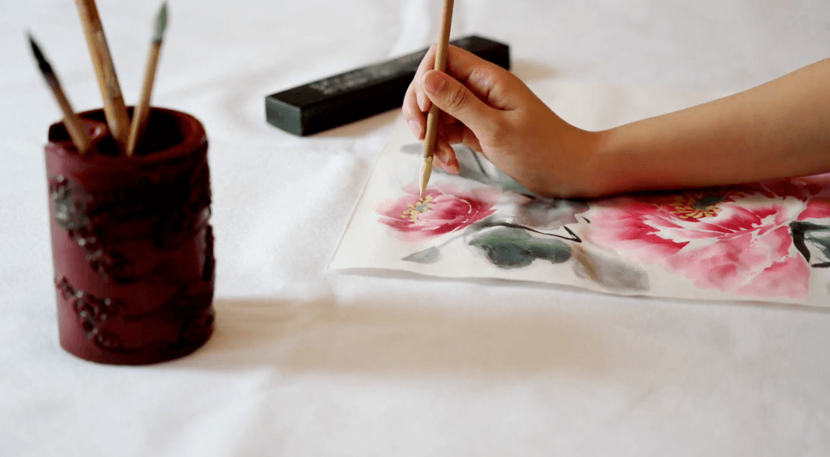 Sherry Ning, a participant in the New Tang Dynasty (NTD) Global Chinese Beauty Pageant., working on a brush painting. (NTD)