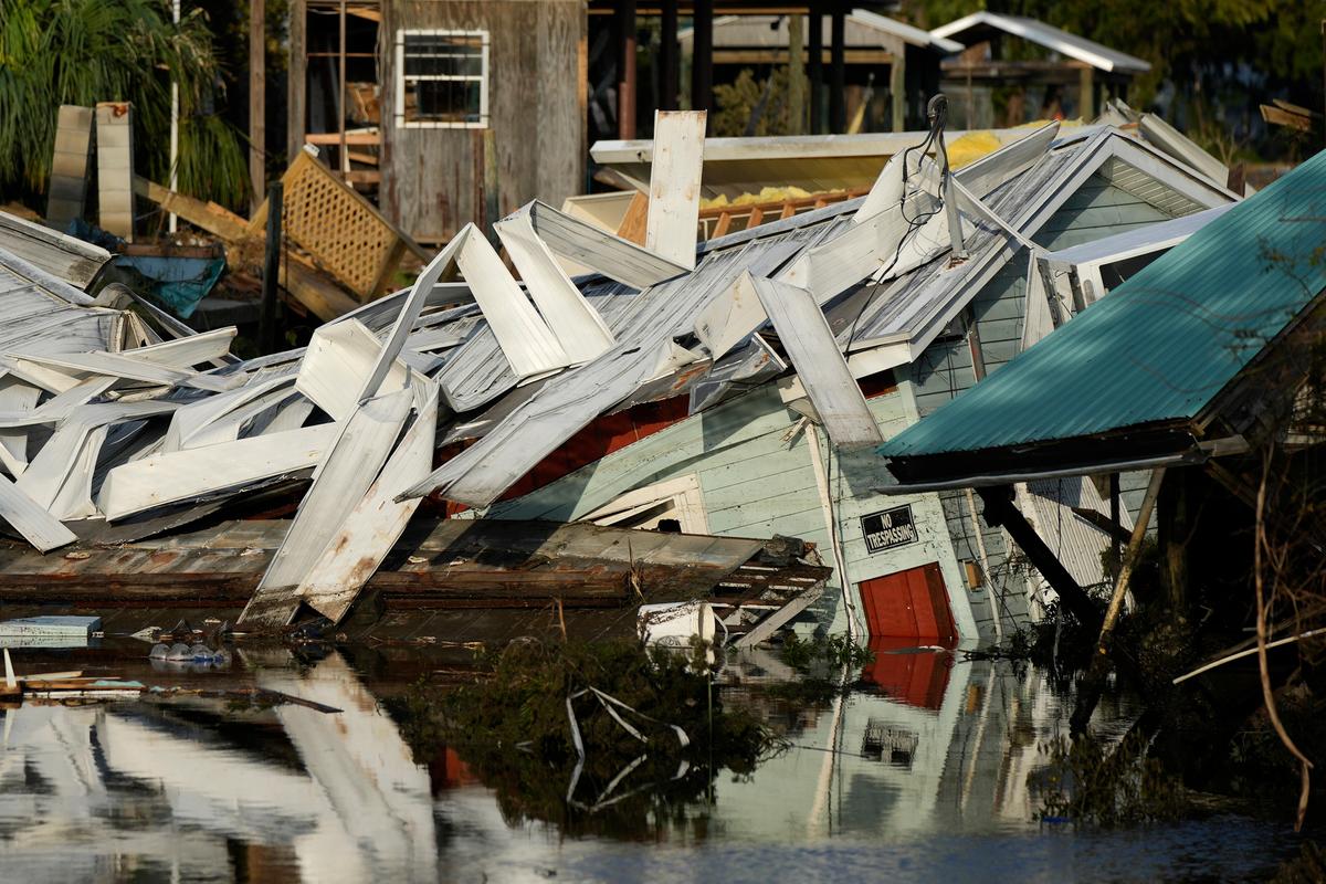 An unstilted home that came off its blocks sits partially submerged in a canal in Horseshoe Beach, Fla., on Sept. 1, 2023, two days after the passage of Hurricane Idalia. (Rebecca Blackwell/AP Photo)