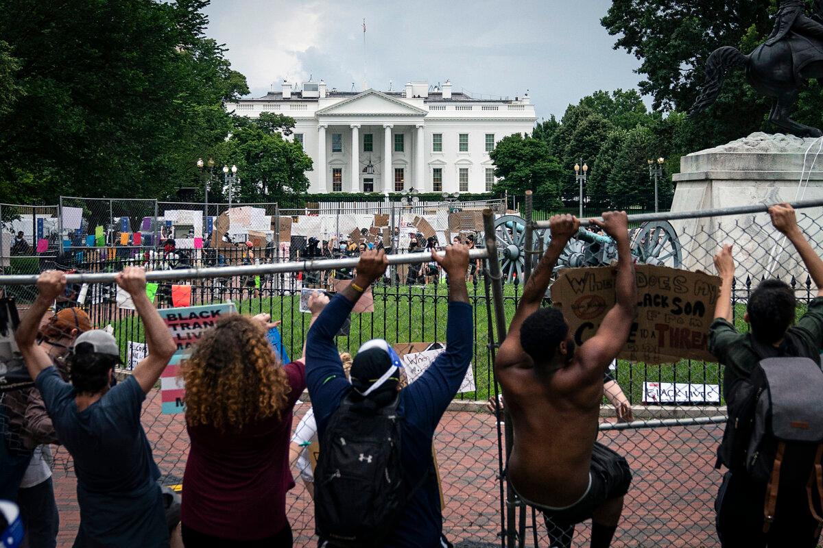 Protesters pull down a fence surrounding the statue of Andrew Jackson in an attempt to topple the statue in Lafayette Square near the White House on June 22, 2020. (Drew Angerer/Getty Images)