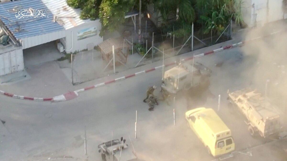 Video footage said to show the armed wing of Hamas taking Israeli army soldiers captive from an armored tank that caught fire on Oct. 7, 2023. (Reuters/Screenshot via NTD)