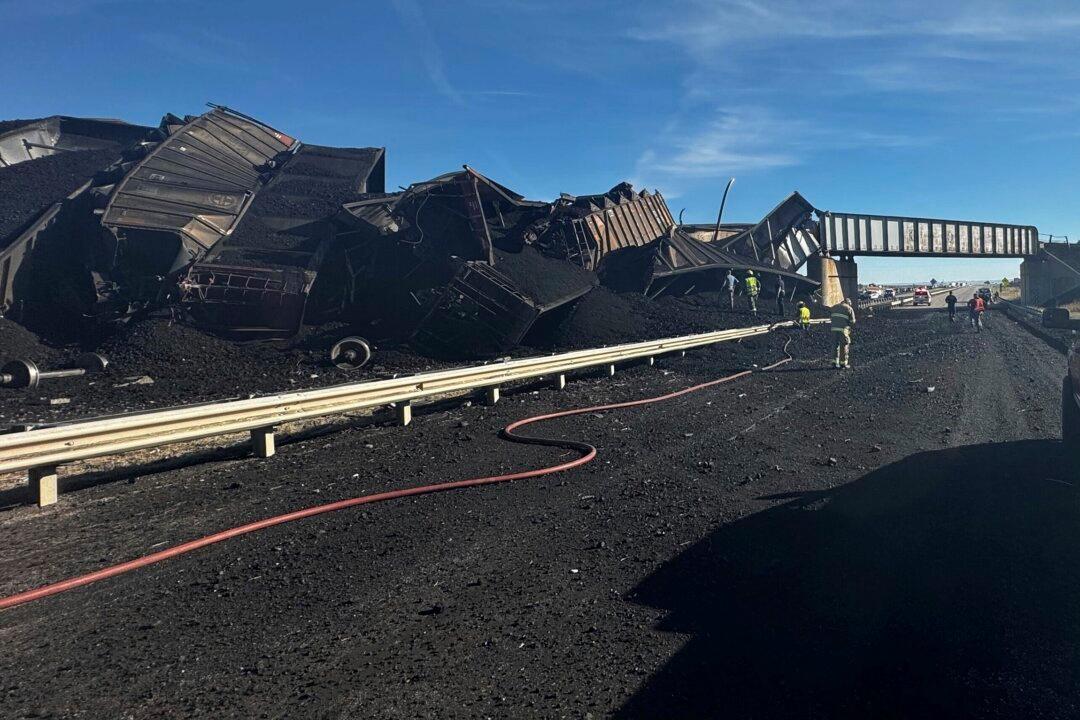 Colorado Train Derails, Spilling Train Cars and Coal Onto Highway and Trapping Semi-Truck Driver