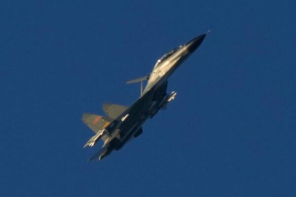 A Chinese J-11 military fighter jet flies above the Taiwan Strait near Pingtan, the closest land of mainland China to the island of Taiwan, in Pingtan in southeastern China's Fujian Province, on Aug. 5, 2022. (AP Photo/Ng Han Guan)