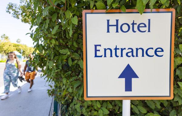 People walk near the former Paradise Pier Hotel in the Disneyland Resort area of Anaheim, Calif., on Oct. 24, 2023. (John Fredricks/The Epoch Times)