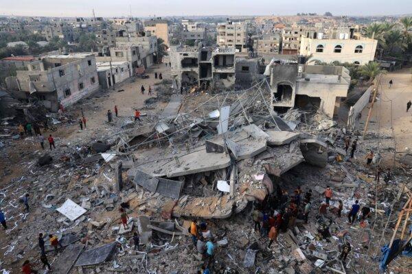 This aerial picture shows people gathered around a destroyed building following Israeli bombing on Rafah in the southern Gaza Strip, on Nov. 11, 2023. (Said Khatib/AFP via Getty Images)