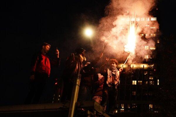 People set off fireworks during a pro-Palestinian protest in London, marching from Hyde Park to the U.S. embassy in Vauxhall, on Nov. 11, 2023. (Aaron Chown/PA)