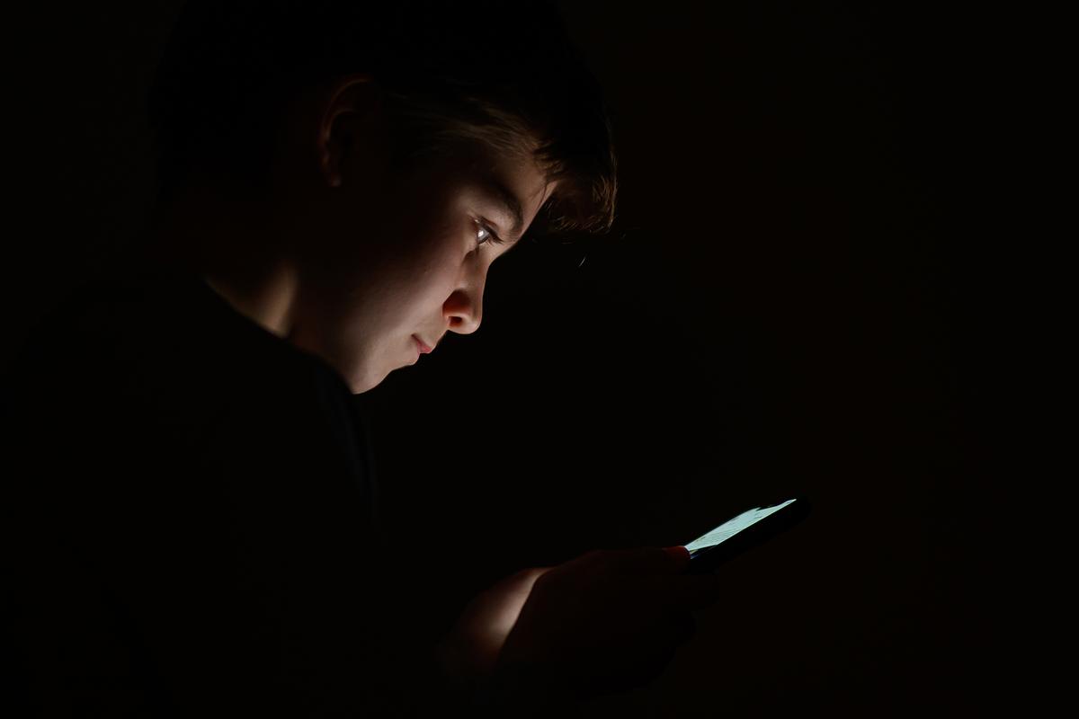 A teenager looks at a cellphone screen in London on Jan. 17, 2023. (Leon Neal/Getty Images)