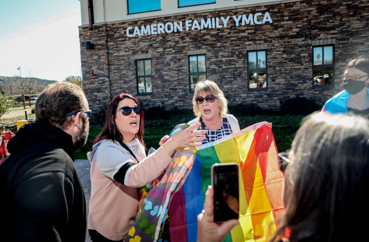 A gender rights activist (C) faces off against protesters rallying against Christynne Wood, a biological male who identified as female and used the women’s locker room at the YMCA in Santee, a suburban city of San Diego County, Calif., on Jan. 21, 2023. (Sandy Huffaker /AFP via Getty Images)