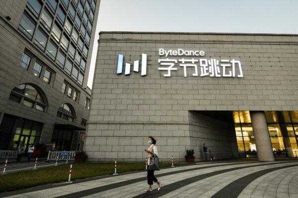 A woman walks past the headquarters of ByteDance, the parent company of video-sharing app TikTok, in Beijing on Sept. 16, 2020. (Greg Baker/AFP via Getty Images)