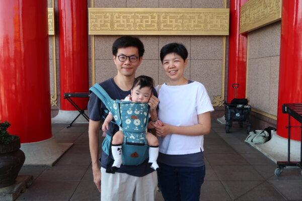 Lo Yu-tang, his wife Chien Lien-ying, and their child at Taiwan’s Liberty Square on Dec. 9, 2023. (Frank Fang/The Epoch Times)