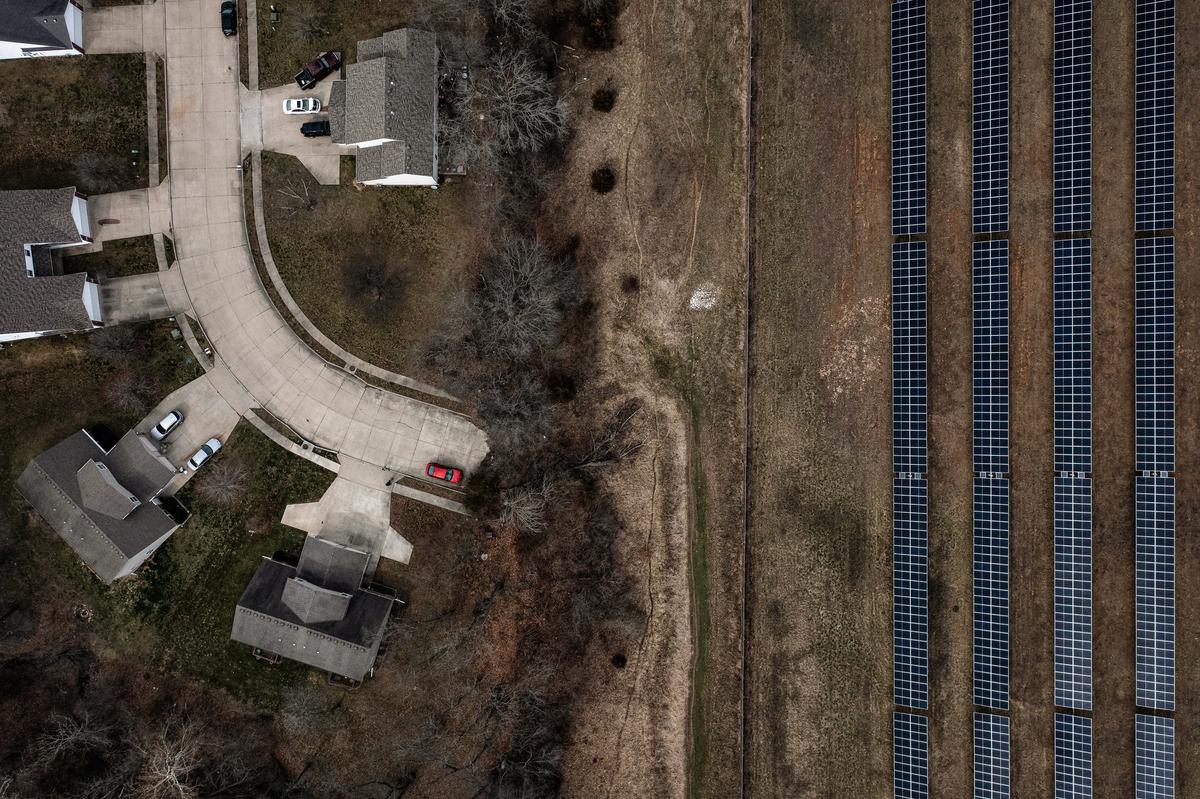An aerial view of a solar farm next to a housing development in Columbia, Mo., on March 15, 2023. (Brendan Smialowski/AFP via Getty Images)