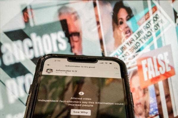 This photo illustration created in Washington, on November 17, 2023, shows a phone screen showing a social media video marked as an "altered video" in front of a fact-checked image of news anchors where the claim about them was found to be false. Stefani Reynolds/AFP)