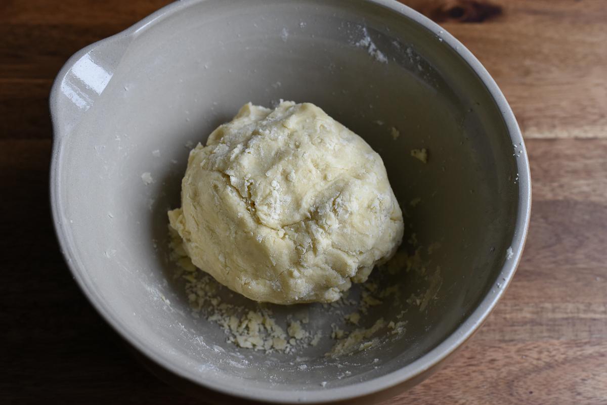 Add the lemon-water and combine until the dough comes together into a ball. (Audrey Le Goff)