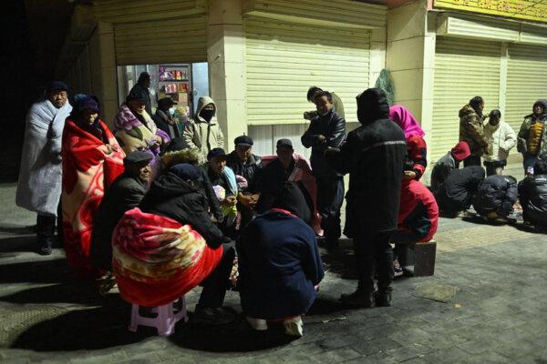 Residents keep warm around fires after an earthquake in Jishishan County, in northwest China's Gansu Province, on Dec. 19, 2023. (CNS/AFP via Getty Images)
