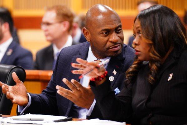Fulton County special prosecutor Nathan Wade, left, and executive district attorney Daysha Young confer during a hearing in the 2020 Georgia election interference case at the Fulton County Courthouse in Atlanta, Ga., on Dec. 1, 2023. (John David Mercer- Pool/Getty Images)