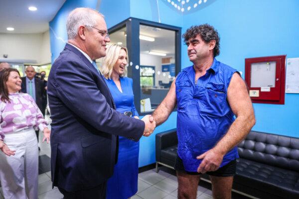 Former Australian Prime Minister Scott Morrison (L) shakes hands with Spudshed's founder, Tony Galati, in Perth, Australia, on May 20, 2022. (Asanka Ratnayake/Getty Images)