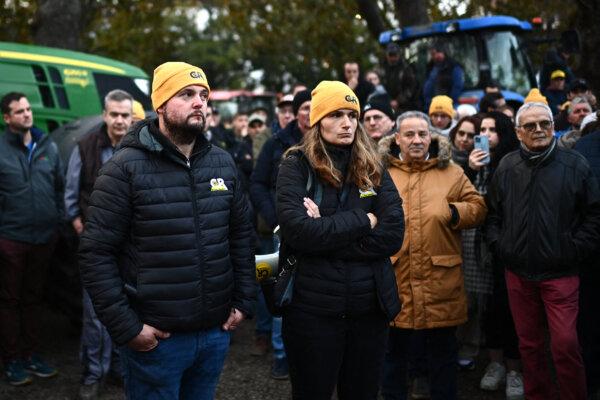 President of the CR47 union (Coordination rurale 47) Jose Perez (L) and vice-president of the CR47 Karine Duc listen to the broadcast press conference of the French Prime minister after their action outside the prefecture in Agen, southwestern France, on Jan. 26, 2024. France's top farmers' union on Jan. 26 began blockading major routes into Paris, upping the pressure on the government to respond to their demands on pay, tax and regulations. Facing his first major crisis, Prime Minister Gabriel Attal was expected to offer concessions as ministers scramble to keep discontent from spreading months ahead of European Parliament elections. (Christophe ARCHAMBAULT/AFP)