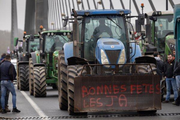 Farmers block the Iroise bridge in Brest, western France, on Jan. 24, 2024, as they protest against taxation and falling incomes. France's powerful agricultural unions met with the French prime minister on Jan. 22, after threatening the government with a week or more of protest action if their demands were not met. (Fred TANNEAU/AFP)