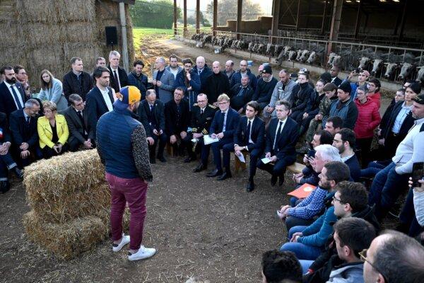 French Prime Minister Gabriel Attal (front row C), French Agriculture and Food Sovereignty Minister Marc Fesneau (C-L) and French Minister for Ecological Transition and Territories' Cohesion Christophe Bechu (C-R) listen to a farmer during a visit in a farm in Montastruc-de-Salies, southwestern France on Jan. 26, 2024, as several farmers unions called for a nationwide day of protests and Attal is expected to make announcements to respond to their demands on pay, tax and regulations. (Miguel MEDINA/AFP)
